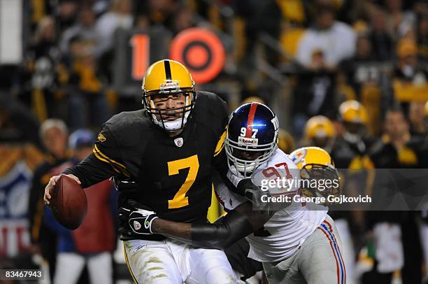 Quarterback Ben Roethlisberger of the Pittsburgh Steelers is sacked by defensive lineman Mathias Kiwanuka of the New York Giants at Heinz Field on...