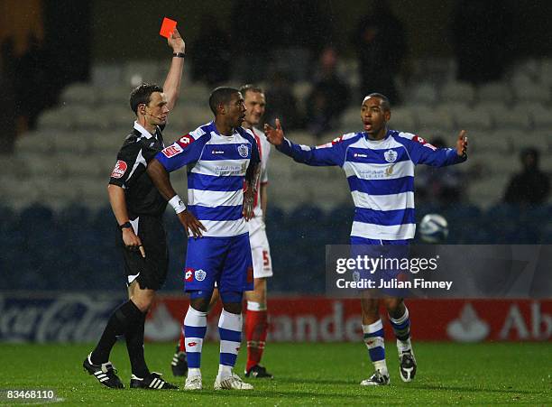 Referee Stiuart Atwell sends off Mikele Leigertwood of QPR during the Coca-Cola Championship match between Queens Park Rangers and Birmingham City at...