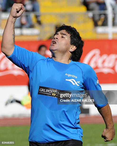 Argentine former soccer star Diego Maradona celebrates after scoring a goal for his team during a charity football match in support of the victims of...