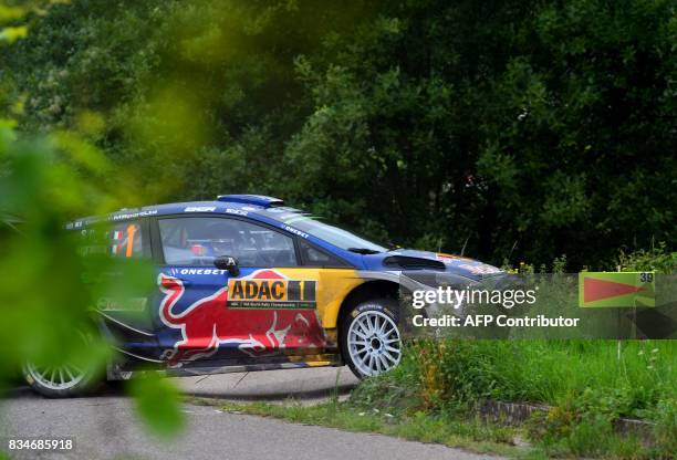 Sebastien Ogier of France and his co-driver Julien Ingrassia of France steer their Ford Fiesta WRC during stage 3 of the Rally Germany in Klueserath...