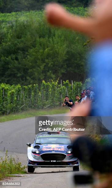 Sebastien Ogier of France and his co-driver Julien Ingrassia of France steer their Ford Fiesta WRC during stage 3 of the Rally Germany in Klueserath...