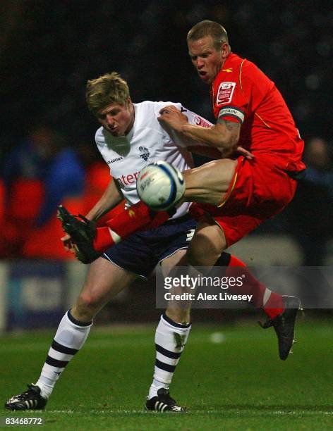 Jay DeMerit of Watford tackles Neil Mellor of Preston North End during the Coca Cola Championship match between Preston North End and Watford at...