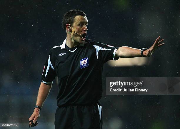 Referee Stuart Atwell gives instructions during the Coca-Cola Championship match between Queens Park Rangers and Birmingham City at Loftus Road on...