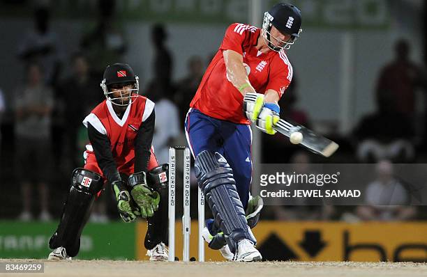 England's cricket team captain Kevin Pietersen "switch" hits the ball off Trinidad and Tobago's bowler Sherwin Ganga as wicketkeeper Denesh Ramdin...