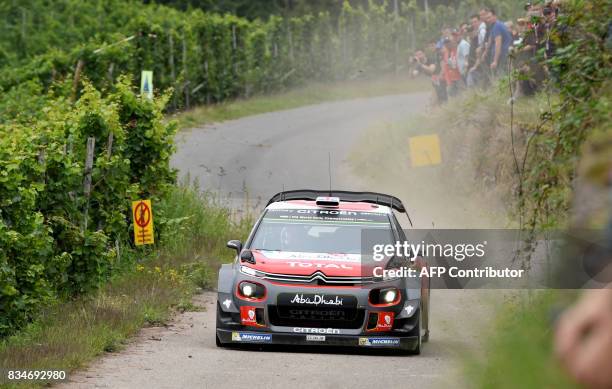 Kris Meeke of Britain and his co-driver Paul Nagle of Ireland steer their Citroen C3 WRC during stage 3 of the Rally Germany in Klueserath near...