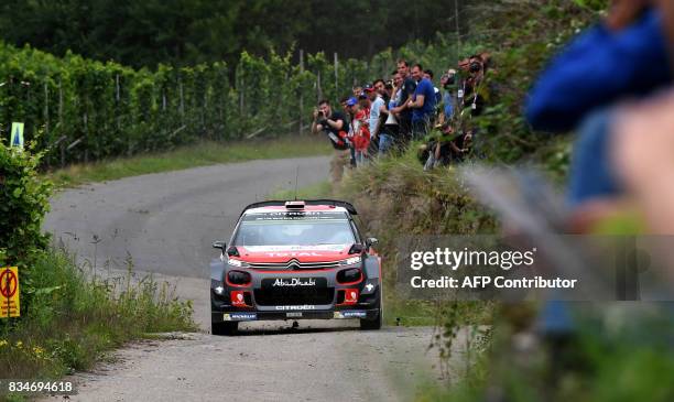 Andreas Mikkelsen of Norway and his co-driver Anders Jaeger of Norway steer their Citroen C3 WRC during stage 3 of the Rally Germany in Klueserath...