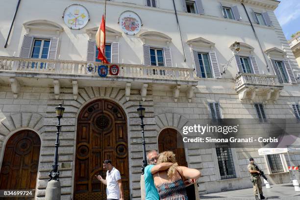 Spanish citizens on holiday in Rome embrace sad in front of the Spanish embassy on August 18, 2017 in Rome, Italy. Flags at half mast in the Spanish...