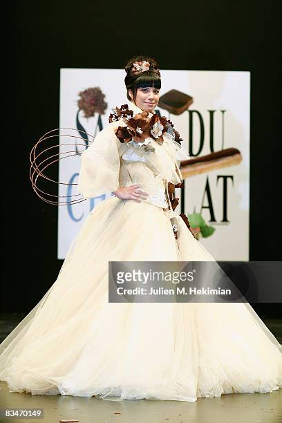 Anne-Gaelle Riccio displays a chocolate decorated dress during the Chocolate dress fashion show celebrating the opening of the 14th Salon du Chocolat...