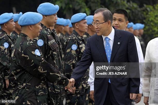 United Nations Secretary General Ban Ki-moon shake hands with members of UN peacekeeping force Philippine contingent during a wreath-laying ceremony...