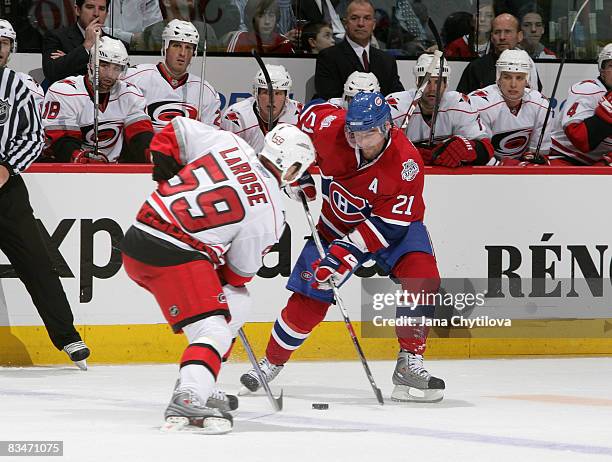 Chad LaRose of the Carolina Hurricanes tries to block a pass against Christopher Higgins of the Montreal Canadiens at Bell Centre on October 28, 2008...