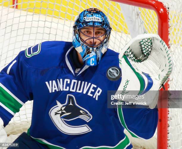 Roberto Luongo of the Vancouver Canucks makes a glove save on the Boston Bruins during their game at General Motors Place on October 28, 2008 in...