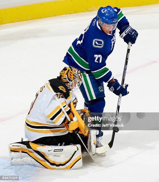 Jason Krog of the Vancouver Canucks tries to score on Tim Thomas of the Boston Bruins during their game at General Motors Place on October 28, 2008...