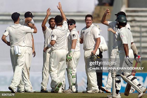 New Zealand cricketers celebrate the dismissal of Bangladeshi batsman Mehrab Hossain during the fifth day of the second and final Test match between...