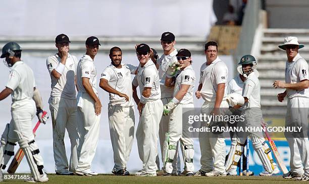 New Zealand cricketers celebrate the dismissal of Bangladeshi batsman Mehrab Hossain during the fifth day of the second and final Test match between...