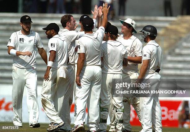 New Zealand cricketers celebrate the dismissal of Bangladeshi batsman Shakib Al Hasan during the fifth day of the second and final Test match between...