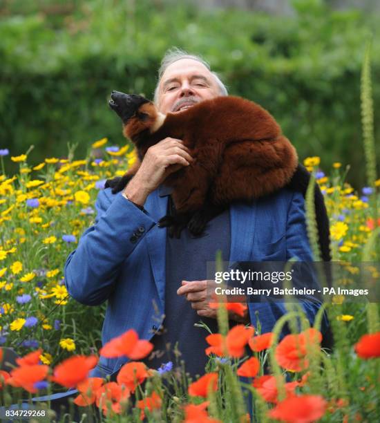 Monty Python star John Cleese meets Colin the red ruffed lemur, during a visit to Bristol Zoo Gardens.