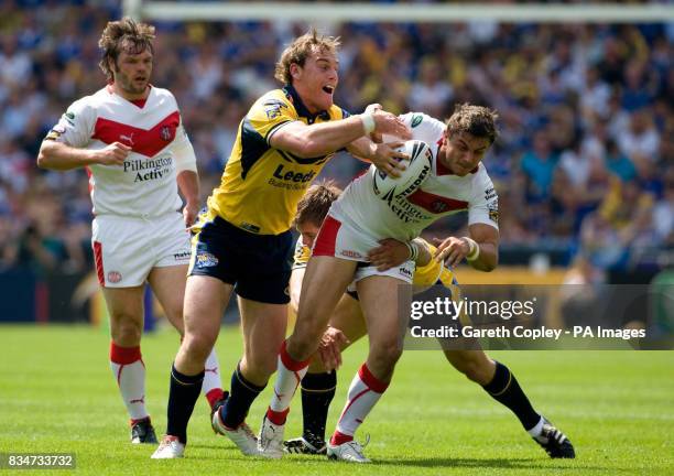 St Helens' Jon Wilkin is tackled by Leeds Rhino's Gareth Ellis and Simon Worrall during the Carnegie Challenge Cup Semi Final at the Galpharm...