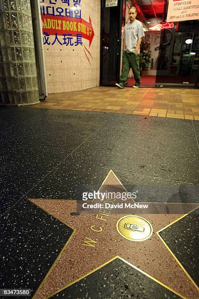 An adult book store and theater operates next to the W. C. Fields star along the Hollywood Walk of fame near the Hollywood landmark intersection of...
