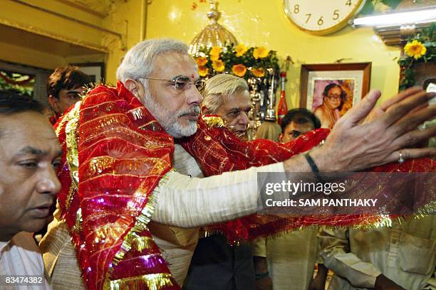 Chief Minister of western India's Gujarat state Narendra Modi offers prayers in front of an unseen idol at the Bhadrakali temple on the occasion of...