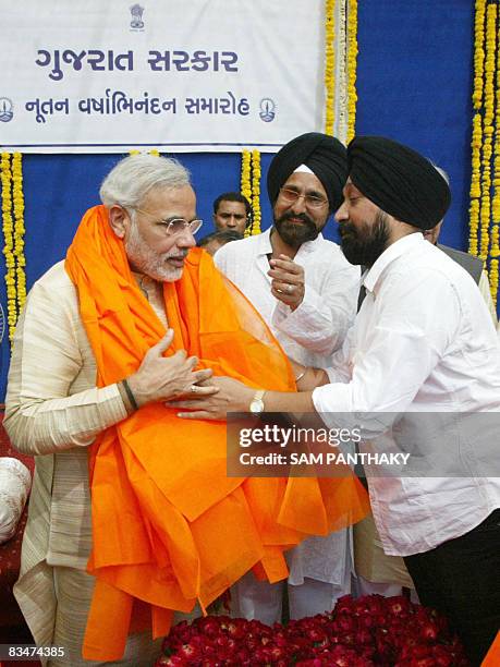 Chief Minister of western India's Gujarat state Narendra Modi is greeted by a group of Sikhs during an event on the occasion of Diwali in Ahmedabad...