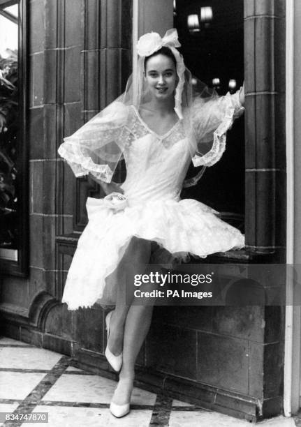 Mantilla-style headress adds a Spanish flavour to this saucy three tier shortie brides dress designed by Beverley Summers which carries a 695 price...