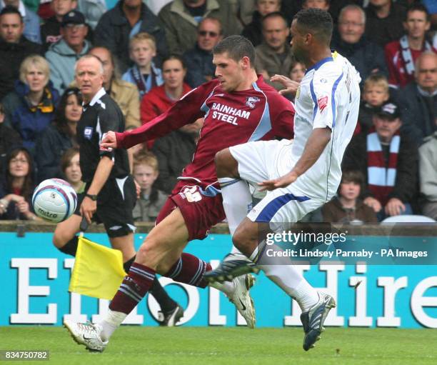 Leeds' Rui Marques tackles Scunthorpe's Gary Hooper during the Coca-Cola Football League One match at Glanford Park, Scunthorpe.