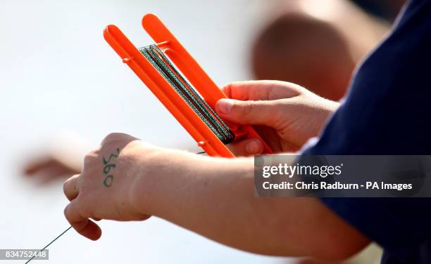 Of a competitor taking part in the annual British Crabbing Championships at Walberswick, Suffolk.