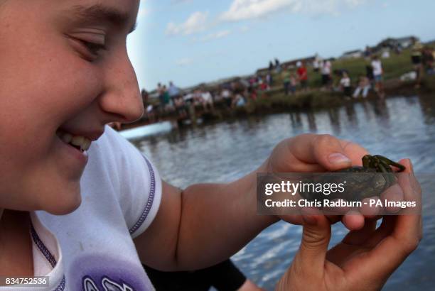 Competitor Tonicha Kent from Lowestoft who takes a closer look at her catch during the annual British Crabbing Championships at Walberswick, Suffolk.