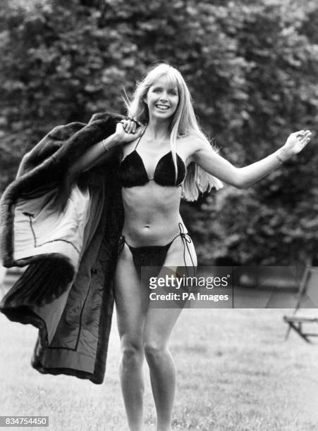 Furrier's daughter Kathy Konrad in a 250 mink bikini and holding a 10.000 mink coat to promote the opening of her father's new fur shop in Piccadilly.
