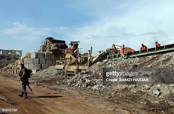 Lebanese soldier patrols as workers remove rubble from the destroyed old part of the Palestinian refugee camp of Nahr al-Bared in northern Lebanon on...