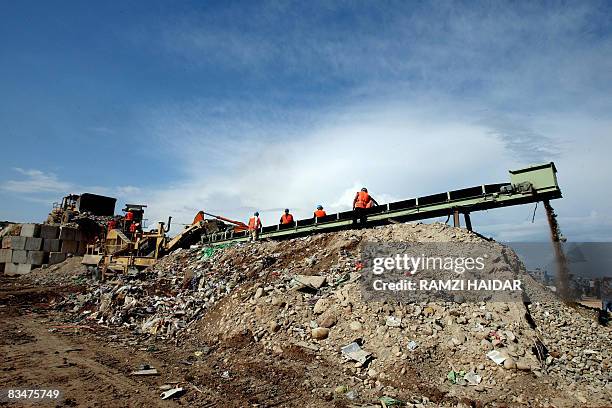 Workers remove rubble from the destroyed old part of the Palestinian refugee camp of Nahr al-Bared in northern Lebanon on October 29, 2008. United...