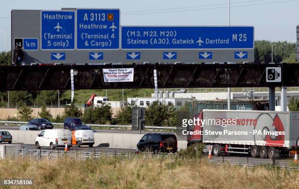 Campaigner Geoffrey Hibbert, believed to be linked to Fathers 4 Justice, dressed as Batman on a gantry over the M25 near Heathrow Airport, London.