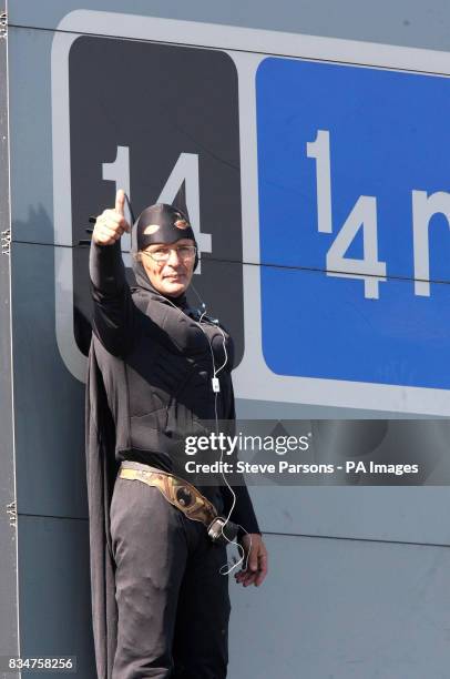 Campaigner Geoffrey Hibbert, believed to be linked to Fathers 4 Justice, dressed as Batman on a gantry over the M25 near Heathrow Airport, London.