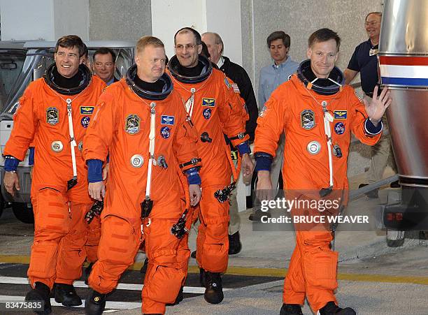 The US space Shuttle Endeavour's Commander Chris Ferguson gives a wave followed by his six person crew, Donald Petit, Pilot Eric Boe, Steve Bowan,...