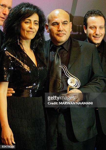 Palestinian director Rashid Mashharawi poses for a picture with his wife Arine after winning the Black Pearl award for Best Screenwriting for his...