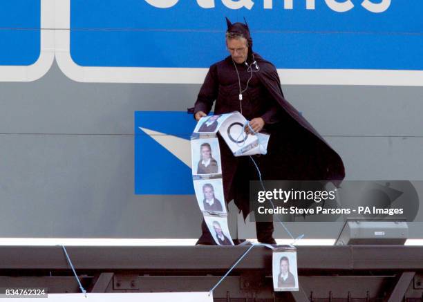 Campaigner, believed to be linked to Fathers 4 Justice, dressed as Batman on a gantry over the M25 near Heathrow Airport, London.