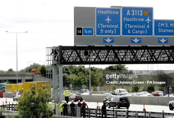 Campaigner, believed to be linked to Fathers 4 Justice, dressed as Batman, climbs down after staging a protest on a gantry over the M25 near Heathrow...