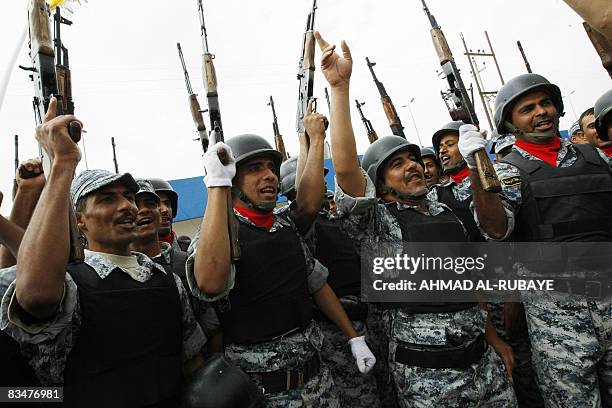 Iraqi soldiers parade at a football stadium in the Wasit provincial capital of Kut on October 29 during a ceremony for the official transfer of...