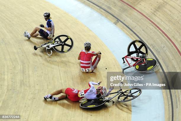 Japan's Satomi Wadami lies on the track following a crash that involved Denmark's Trine Schmidt and USA's Sarah Hammer during the Track Cycling...