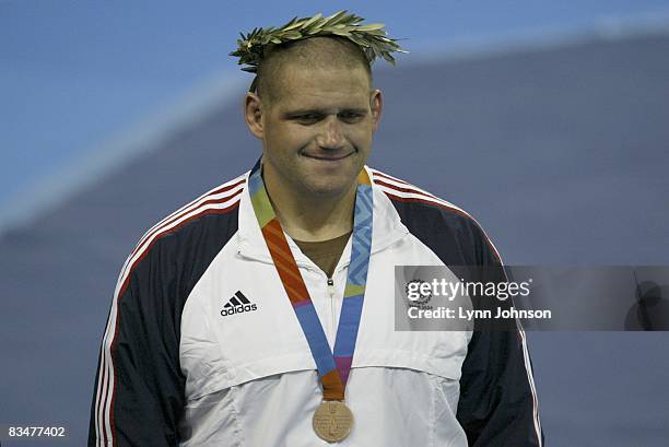 Greco-Roman Wrestling: 2004 Summer Olympics: USA Rulon Gardner victorious on medal stand after Men's 96kg-120kg bronze medal match at Ano Liossia...