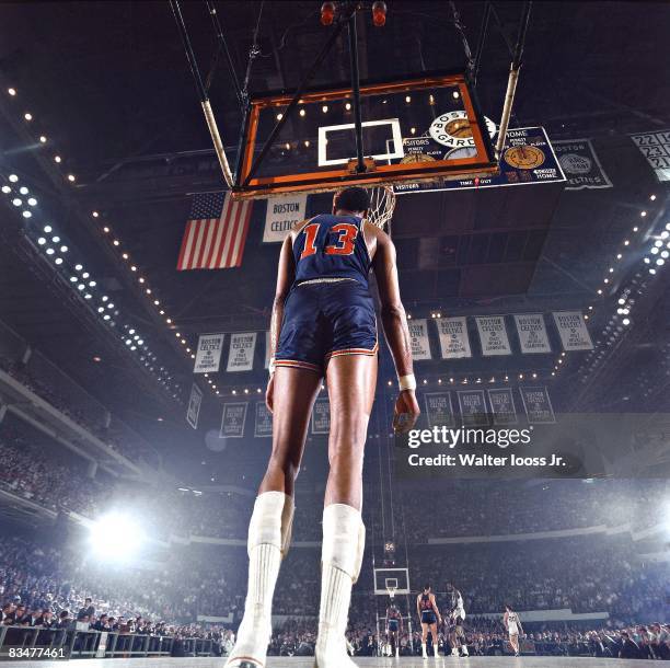 Playoffs: Rear view of Philadelphia 76ers Wilt Chamberlain , on court during game vs Boston Celtics, and, in the background the scoreboard at Boston...