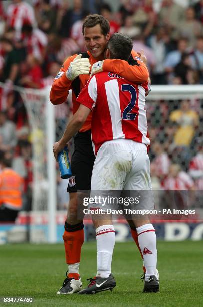 Stoke City goalkeeper Thomas Sorensen celebrates with teammate Andy Griffin after the final whistle.