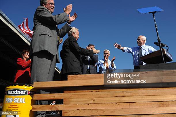 Republican presidential candidate Arizona Senator John McCain moves to shake hands with Senator Joe Liberman during a campaign rally at Everglades...