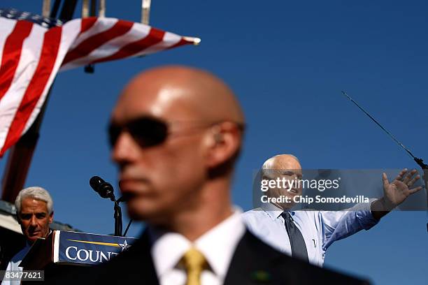 Secret Service agent stands in front of Republican presidential nominee Sen. John McCain as he addresses a campaign rally with Florida Governor...