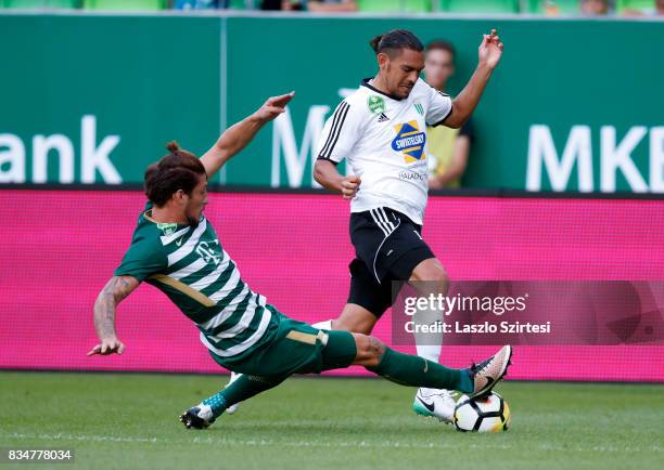 Bence Batik of Ferencvarosi TC slide tackles David Williams of Swietelsky Haladas during the Hungarian OTP Bank Liga match between Ferencvarosi TC...