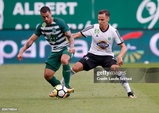 Marcos Pedroso of Ferencvarosi TC competes for the ball with Mate Toth of Swietelsky Haladas during the Hungarian OTP Bank Liga match between...