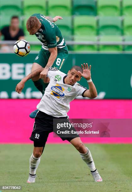 Gergo Lovrencsics of Ferencvarosi TC battles for the ball in the air with Myke Bouard Ramos of Swietelsky Haladas during the Hungarian OTP Bank Liga...