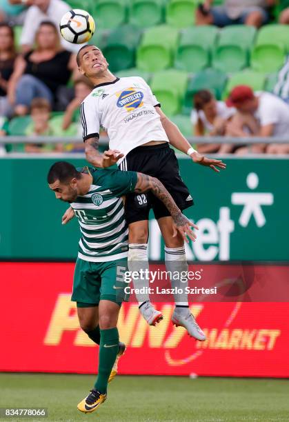 Myke Bouard Ramos of Swietelsky Haladas wins the ball in the air from Marcos Pedroso of Ferencvarosi TC during the Hungarian OTP Bank Liga match...