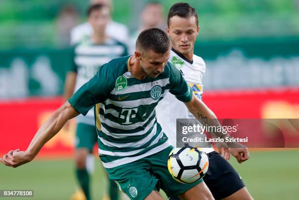 Tamas Priskin of Ferencvarosi TC wins the ball from Zoltan Medgyes of Swietelsky Haladas during the Hungarian OTP Bank Liga match between...