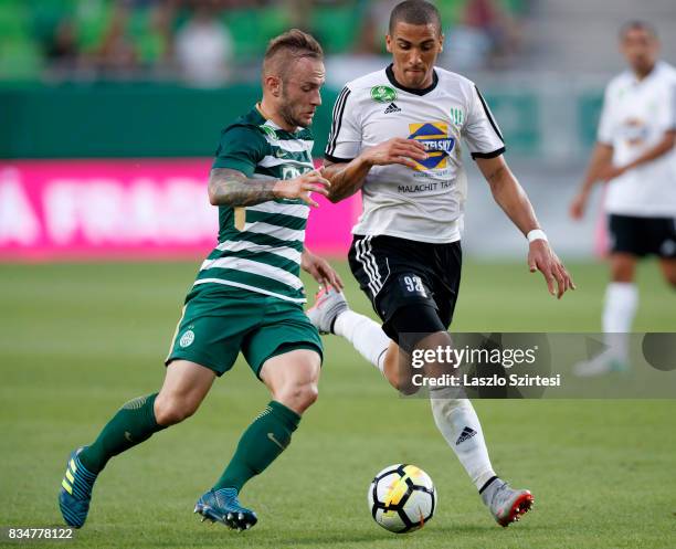 Gergo Lovrencsics of Ferencvarosi TC duels for the ball with Myke Bouard Ramos of Swietelsky Haladas during the Hungarian OTP Bank Liga match between...